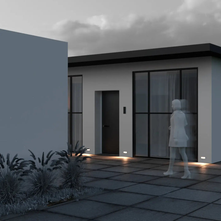 Maison moderne minimaliste avec applique encastrable bosca d’une allée sur patio gris foncé carrelé