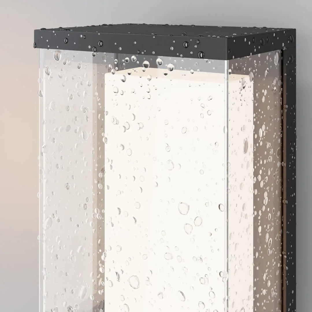 Applique extérieure baker street en aluminium noir avec verre texturé à bulles et lumière blanche chaude centrale