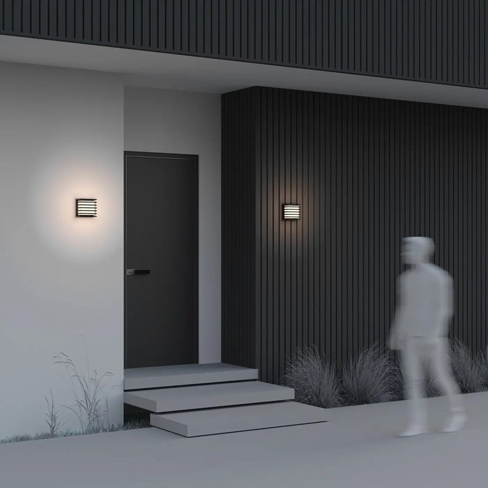 Applique extérieur downing street en aluminium noir avec verre opale et lames horizontales diffusant une lumière chaude