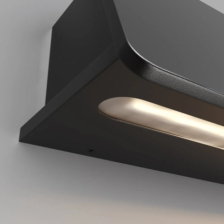 Applique extérieure led en acier noir avec finition mate noire et bande led chaude intégrée près d’une porte