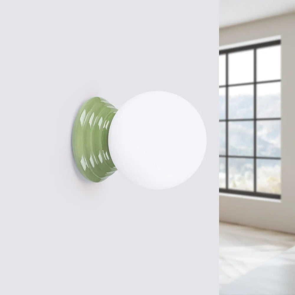Applique murale lampe zori avec globe sphérique blanc mat et base en céramique vert sauge texturée pour belle décoration