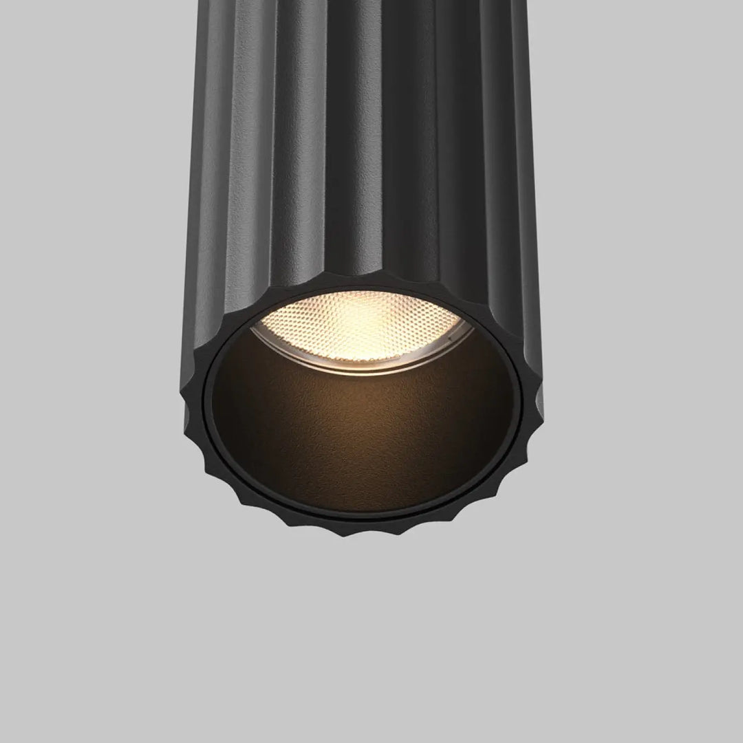 Applique murale calipso led linéaire cylindrique noire avec texture cannelée et lumière led linéaire chaude diffuse
