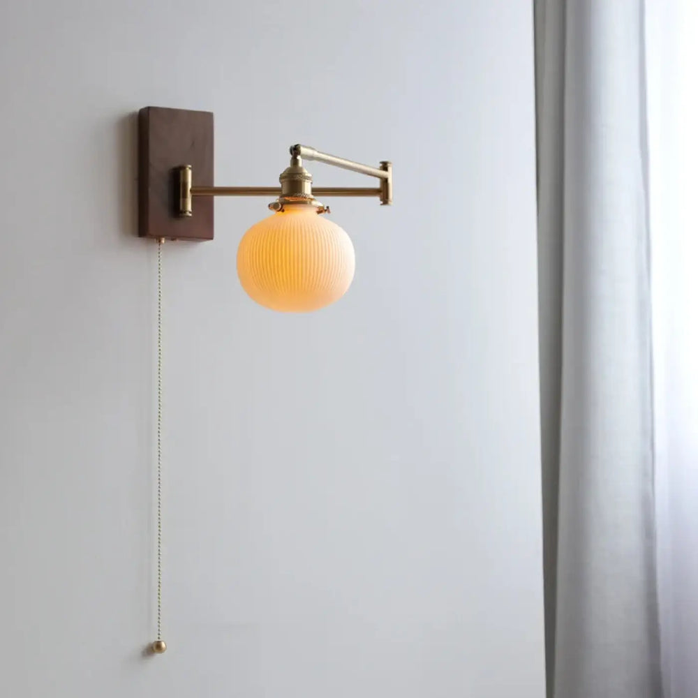 Applique murale contemporaine en laiton fini avec globe en verre dépoli cannelé et plaque arrière en bois foncé pinoca