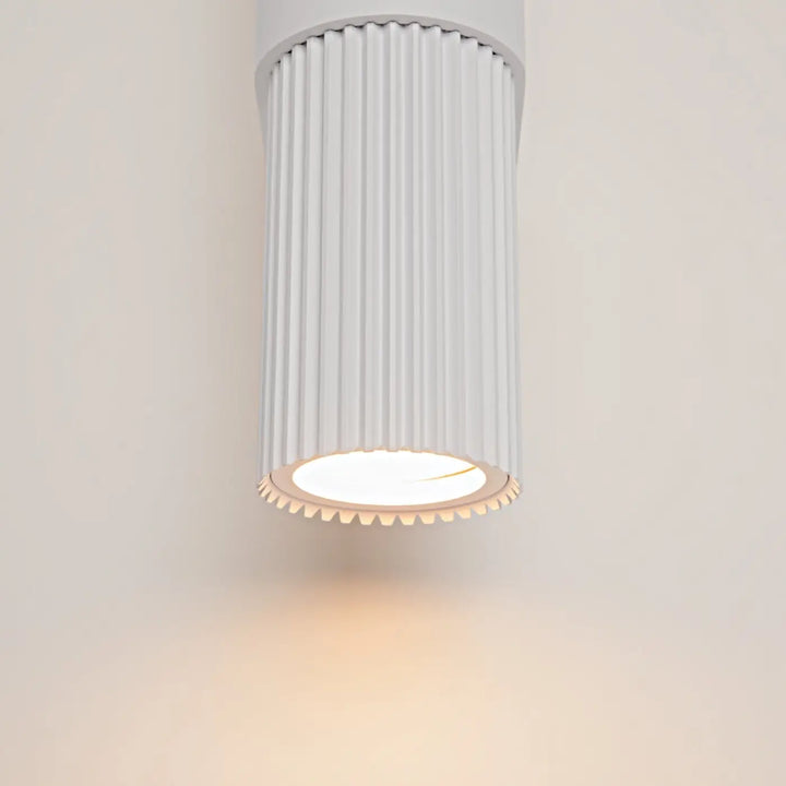 Applique murale dynamics cylindre strié blanc avec lumière chaude circulaire en bas monté au mur