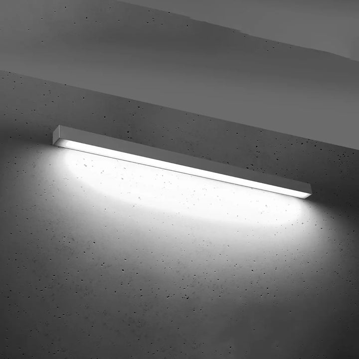 Applique murale pinne 118 4000k gris avec module led blanc rectangulaire monté sur mur en béton pour collection pinne paramètres d’éclairage