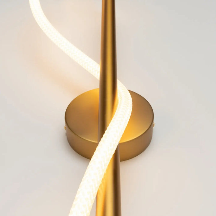 Applique murale led tau en métal doré avec cordon led torsadé et base circulaire minimaliste