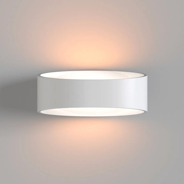 Applique murale trame elliptique blanche cylindrique avec lumière rasante douce et design minimaliste