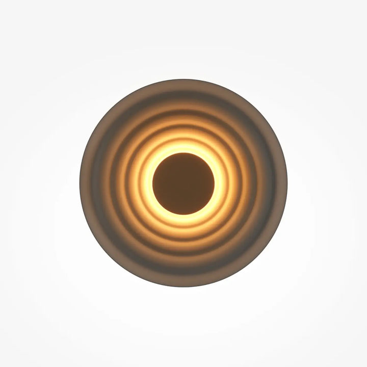 Applique murale nami disque ondulé avec un anneau concentrique diffusant une lumière ambre chaude