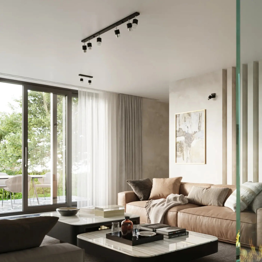 Applique murale collection nero en chrome avec canapé sectionnel en cuir beige et coussins texturés pour nombreuses façons