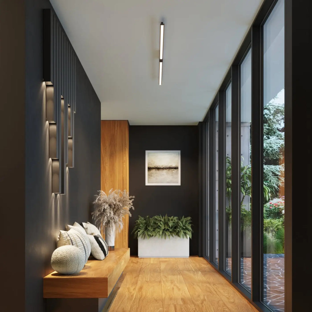 Applique murale freya 60 noir avec plante verte dans un compose d’appliques murales minimalistes de la collection freya cinq coloris