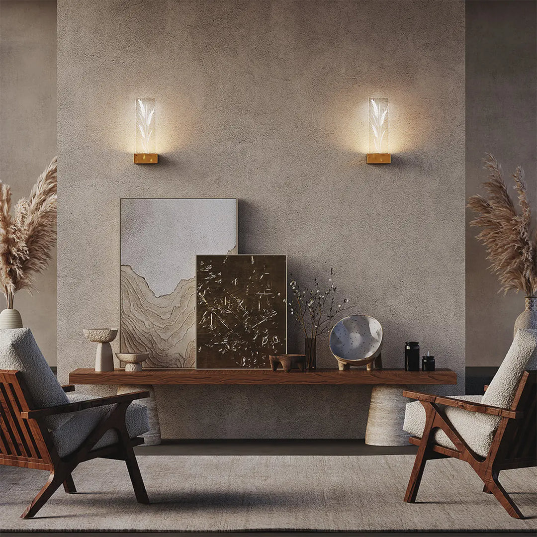 Deux appliques murales ornate avec bases dorées et abat-jour en verre clair émettant une lumière chaude