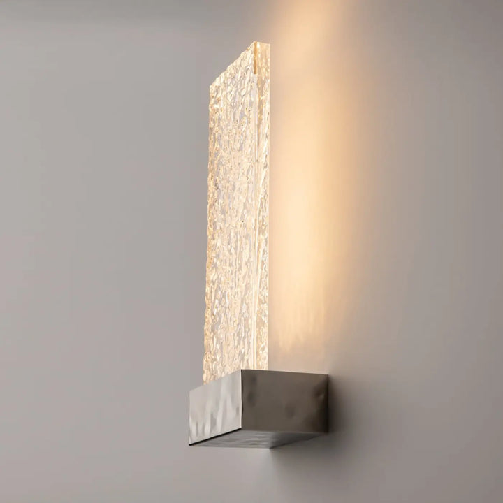Applique murale ornate avec panneau de verre translucide texturé et lumière chaude sur base métallique moderne