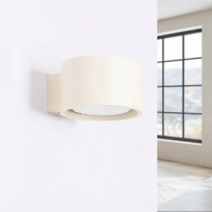 Applique murale ronde beige éteinte, installée au mur