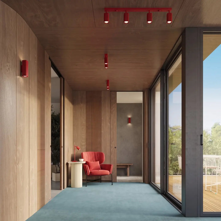 Applique murale Rayo en aluminium rouge à réflecteur rainuré dans une chambre