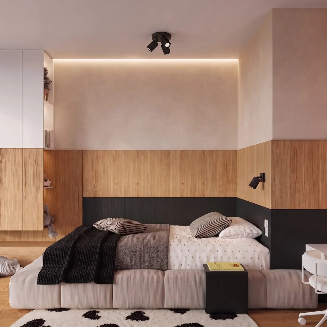 Applique murale Rayo en aluminium noir à réflecteur rainuré dans une chambre