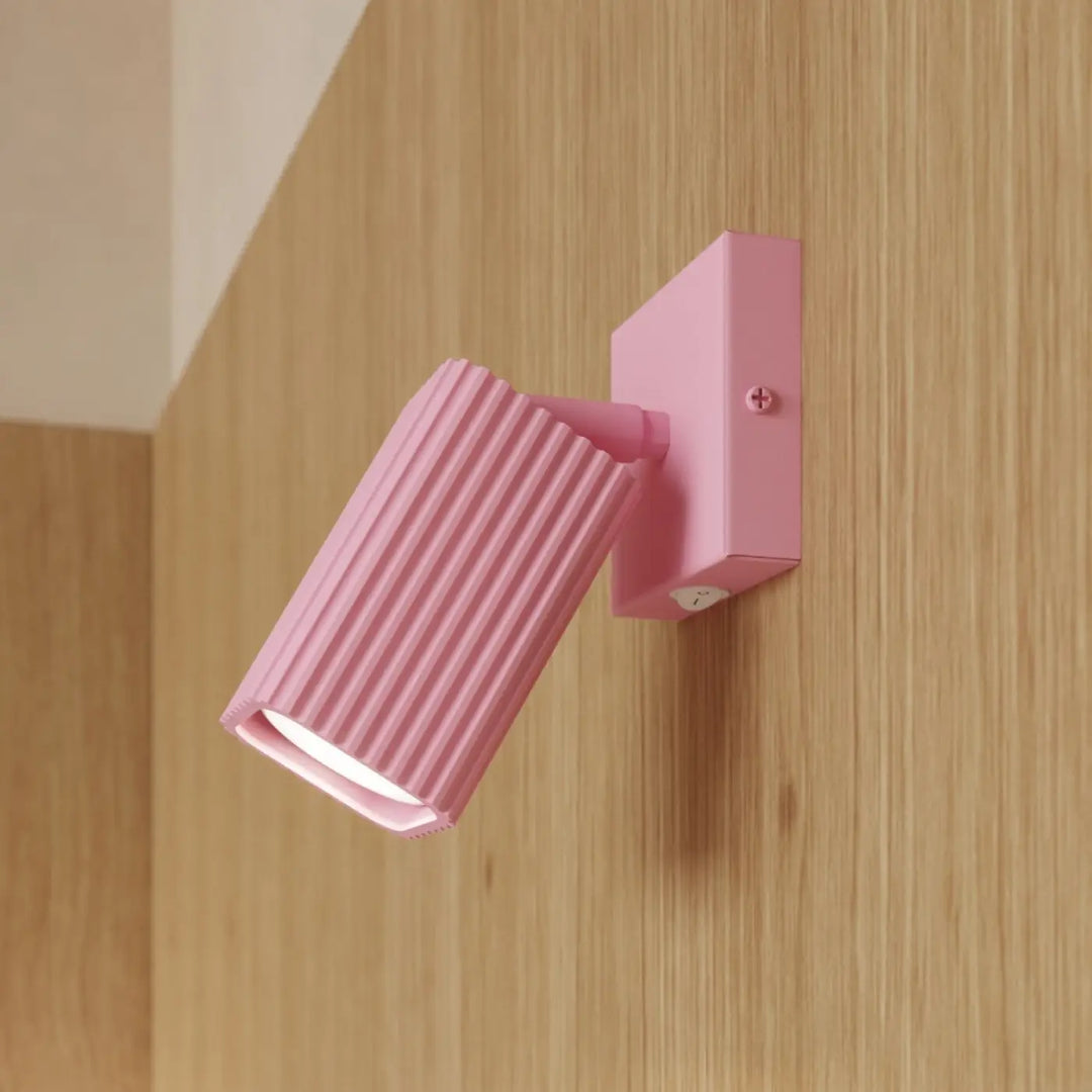 Applique murale Rayo en aluminium rose à réflecteur rainuré, fixée au mur, vue rapprochée