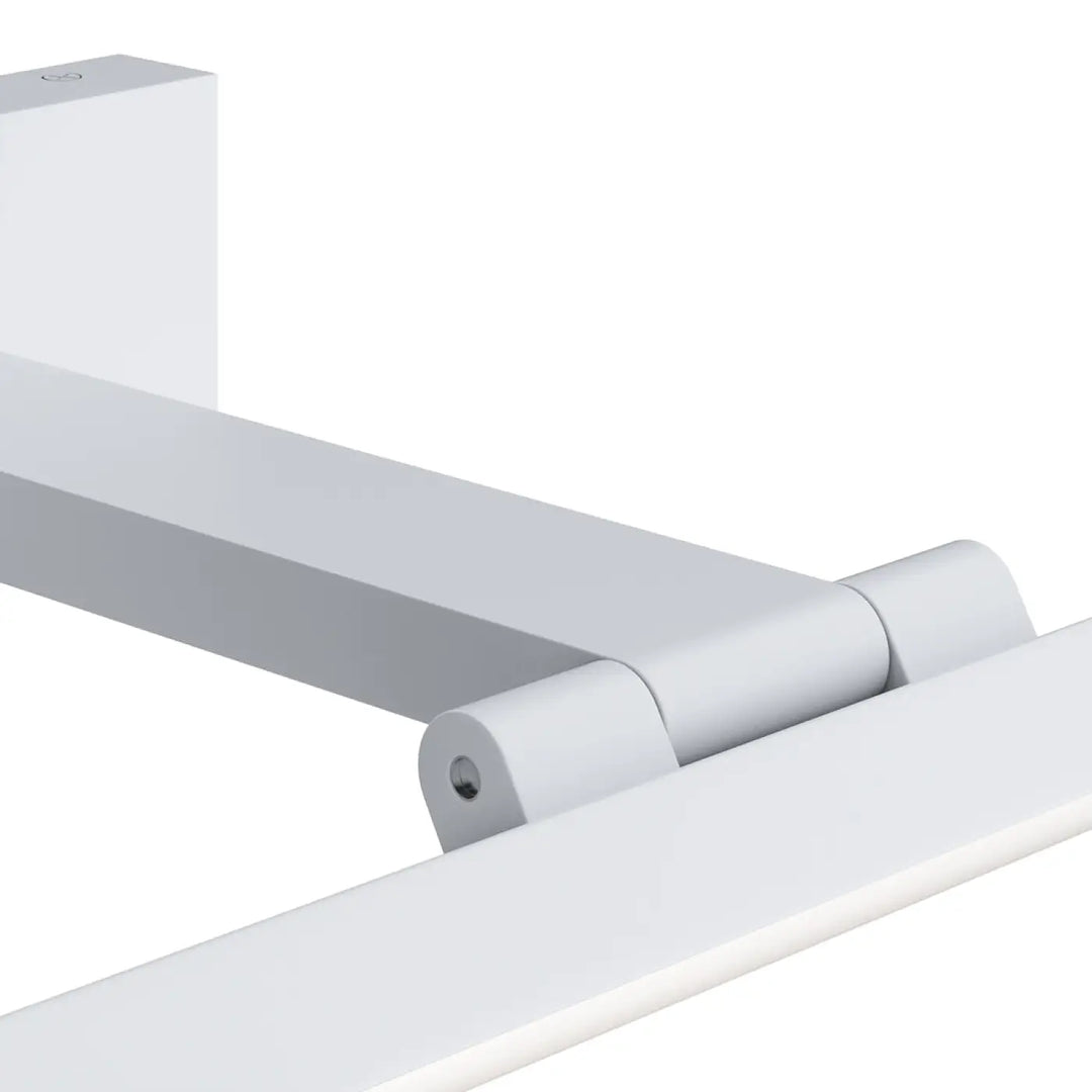 Applique murale bris en métal blanc avec charnière lisse au-dessus d’un miroir d’une lumière tête orientable