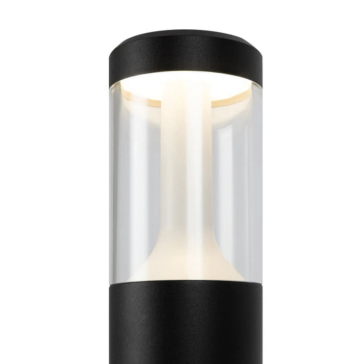 Borne extérieure cylindrique acier noir avec lumière claire led dans un lanterne moderne en verre transparent
