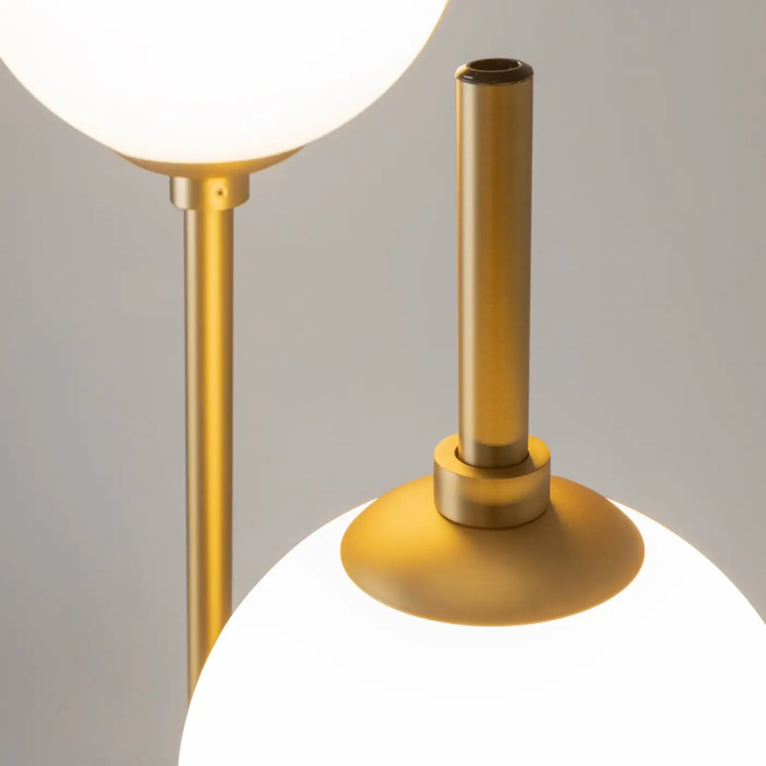 Lampadaire sixth sense en finition or avec deux globes sphériques en verre dépoli pour un éclairage élégant