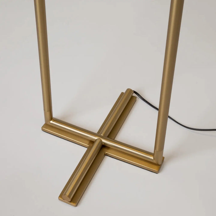 Lampadaire sixth sense en métal doré avec base en forme de croix et tiges verticales pour un éclairage élégant