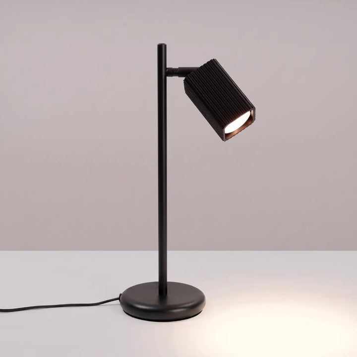 Lampe de bureau Rayo en aluminium noir à réflecteur rainuré, allumée