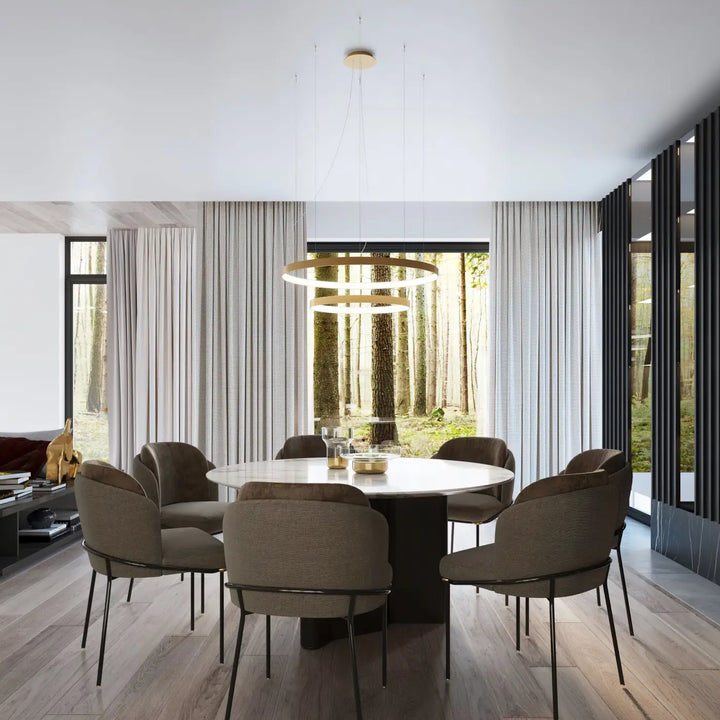 Plafonnier rio moderne en anneaux dorés concentriques avec modules led offrant une efficacité lumineuse élevée au-dessus d’une table à manger