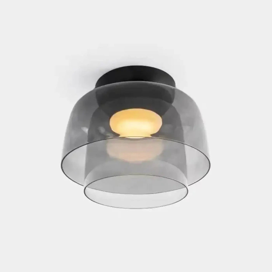 Luminaire plafonnier moderne avec base circulaire noire et abat-jour en verre translucide gris superposé