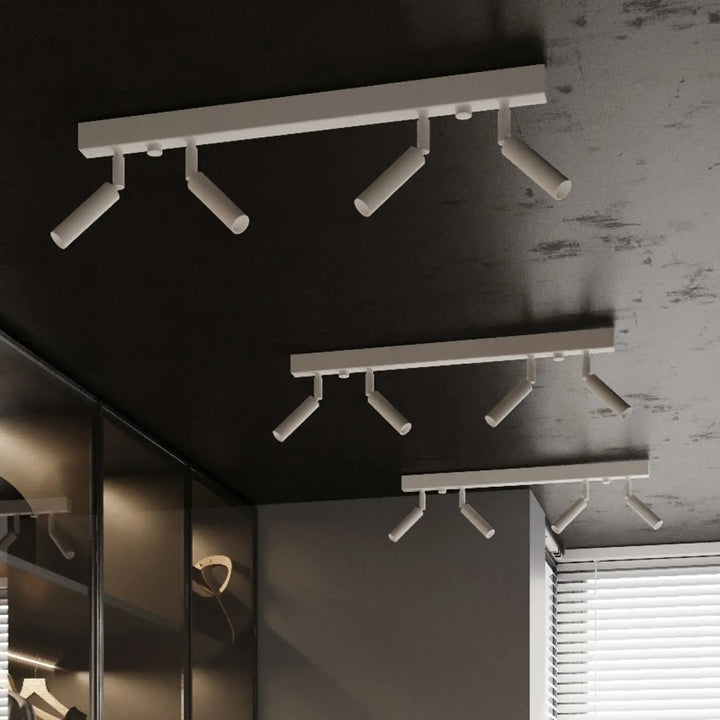 Plafonnier moderne eyetech blanc avec spots orientables style industriel pour une ambiance loft sur plafond sombre