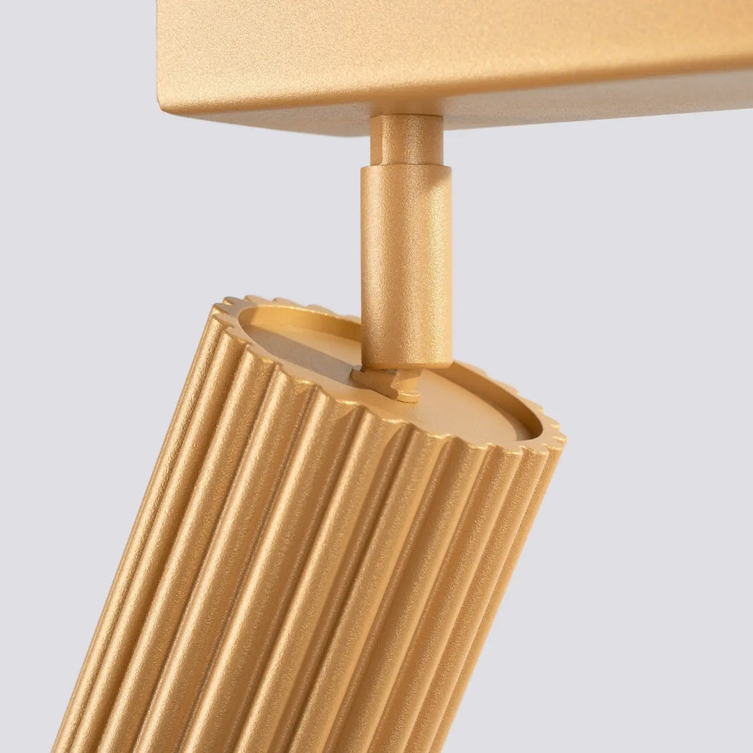 Plafonnier karbon allie un design minimaliste avec abat-jour cylindrique doré à finition métallique et ampoules gu10 interchangeables