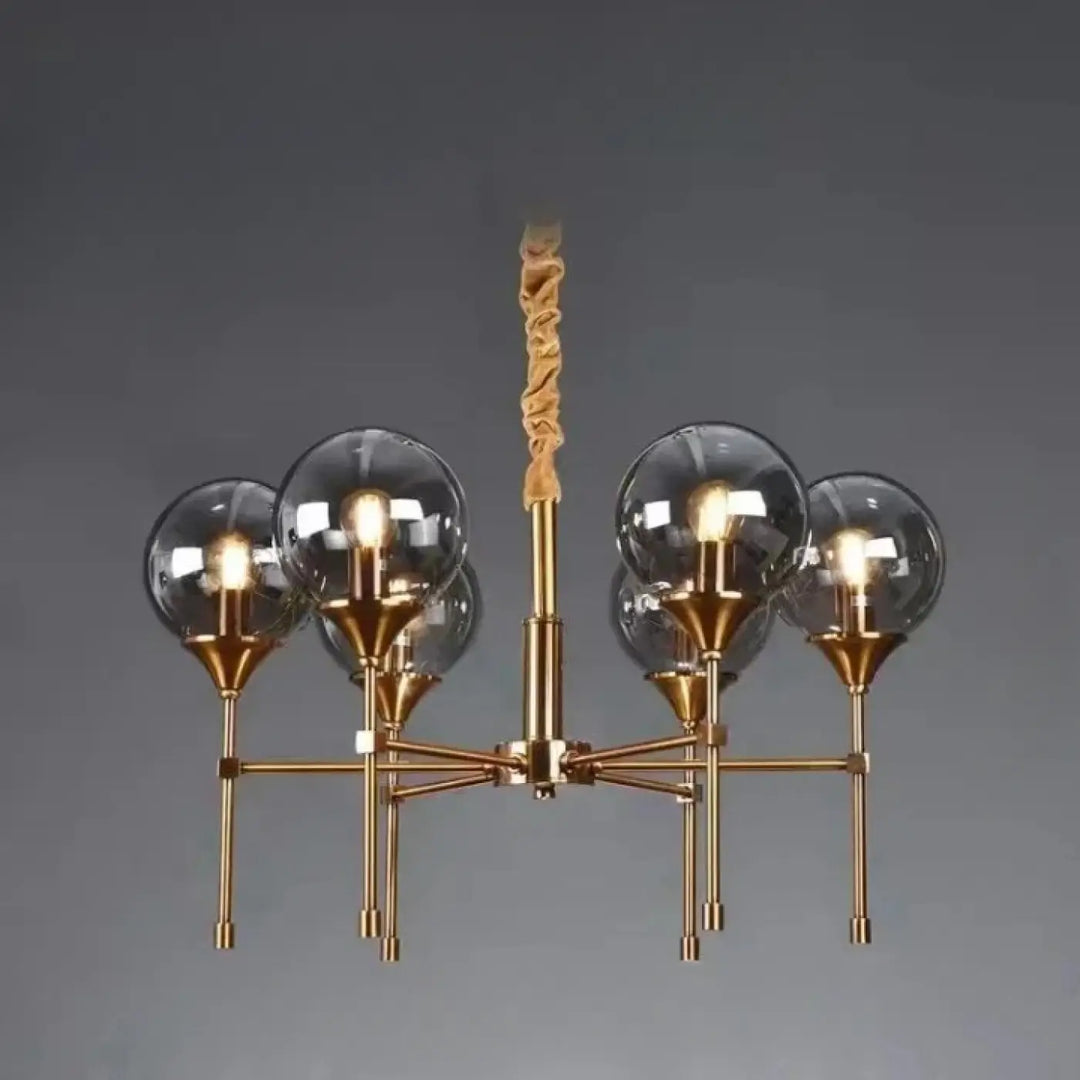 Suspension luminaire bublor en finition laiton avec cinq globes en verre clair et tige torsadée en tissu pour éviter frais supplémentaires