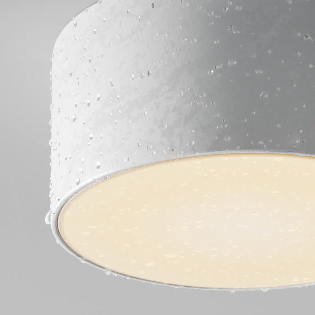 Plafonnier zon extérieur led cylindrique blanc texturé avec finition subtile et lumière chaude diffusée doux