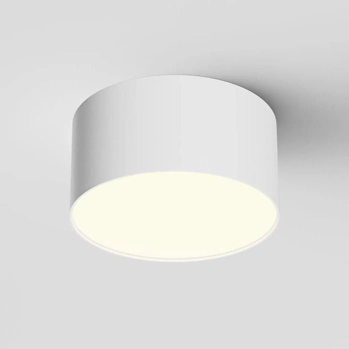 Plafonnier led zon blanc cylindrique avec profil fin et rond minimaliste diffusant une lumière douce et moderne