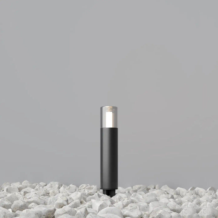 Potelet extérieur en acier noir cylindre fin glide avec lumière blanche douce et verre transparent