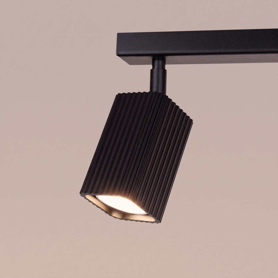 Plafonnier Rayo noir en rampe à spots orientables, détail des cannelures
