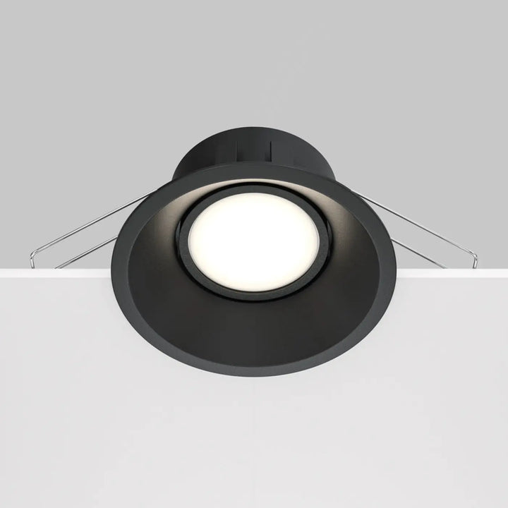 Spot encastrable dot rond en finition mate noire avec design circulaire et fils de montage visibles au dos