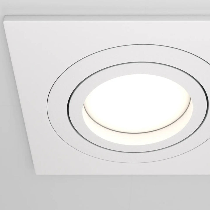 Spot encastrable double carré blanc avec centre circulaire lumineux et design à anneaux concentriques pour éclairage intérieur