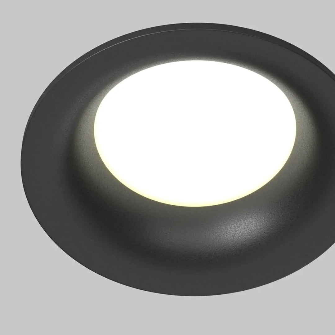 Spot encastré rond discret avec finition mate noire et panneau central blanc pour éclairage général uniforme