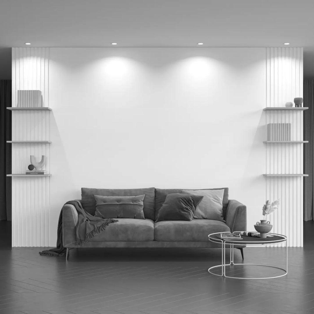 Canapé en velours gris avec coussins assortis et plaid drapé dans un spot yin avec ampoule gu10 spot encastré