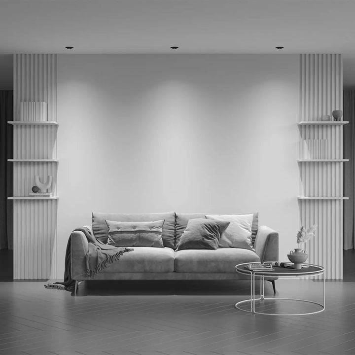 Canapé en velours gris avec coussins capitonnés et plaid drapé dans spot hidden led rétractable acier noir