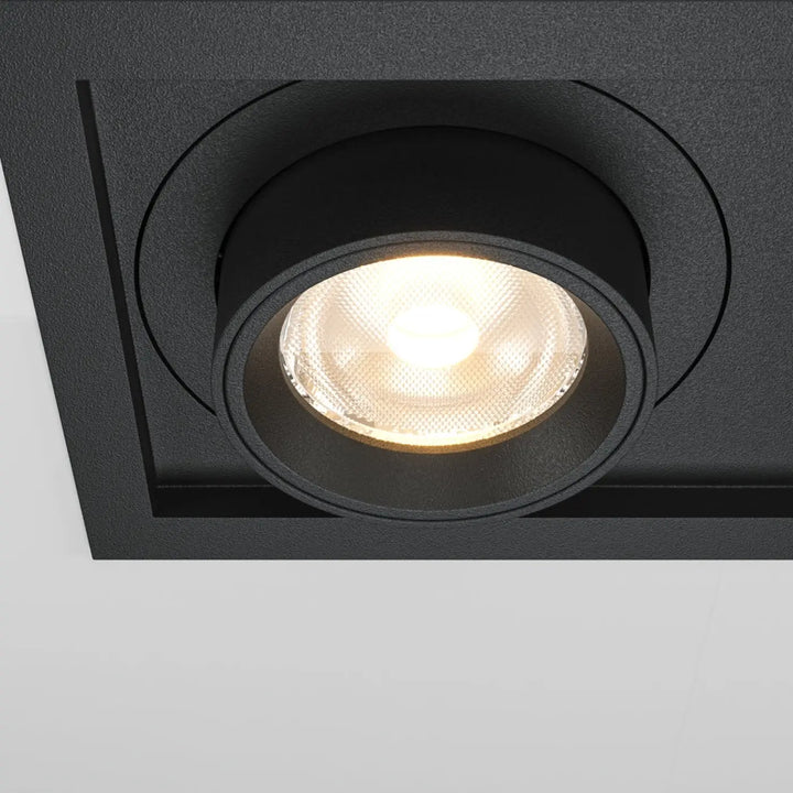 Spot hidden led rétractable en acier noir avec finition texturée circulaire et ampoule led intégrée allumée