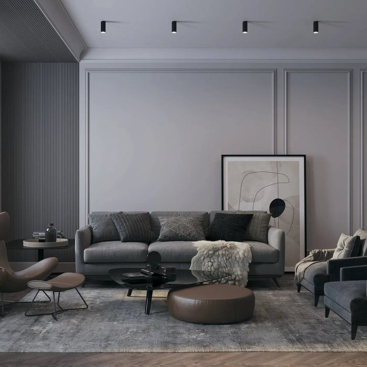 Canapé spot focus compact gris avec coussins texturés et couverture blanche, idéal pour lumière dirigée petit cylindre