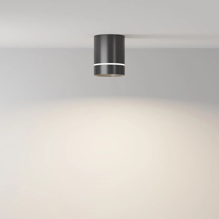 Spot orlo cylindre compact en acier noir avec finition mate et bande blanche fine pour éclairage plafonnier