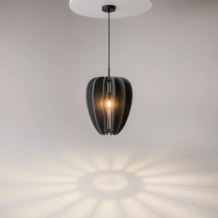 Suspension luminaire cambio coupole en aluminium noir avec lumière chaude et motif dombre radiale au-dessus d’une table
