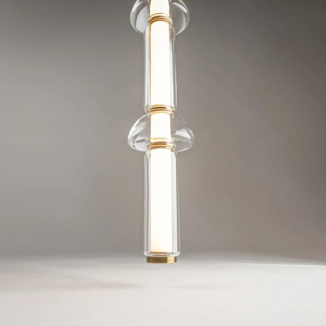 Suspension luminaire cosmo linéaire en verre transparent avec accents métal doré et design minimaliste led linéaire