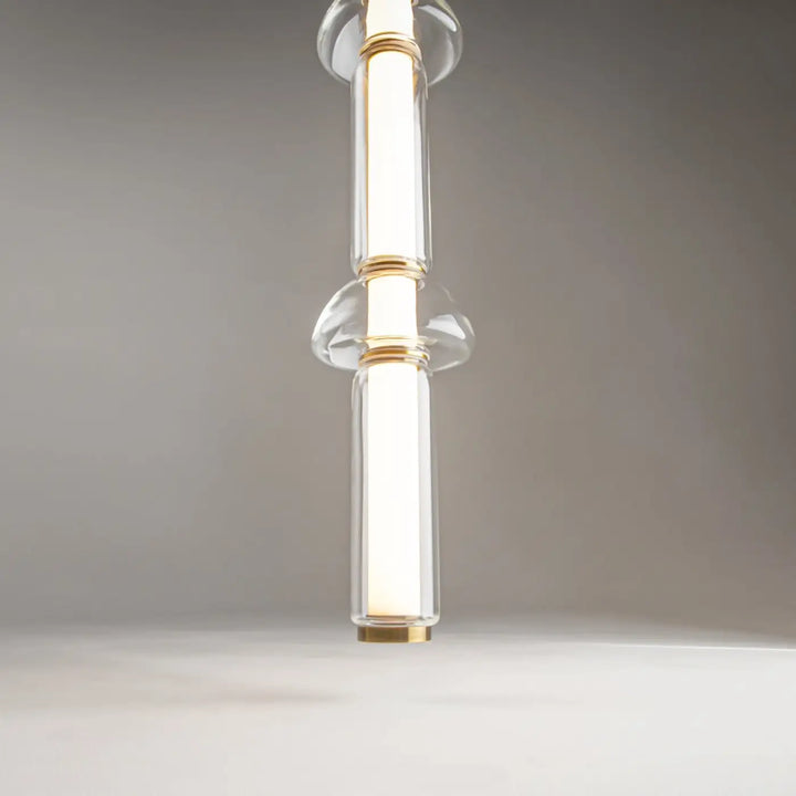Suspension luminaire cosmo linéaire en verre transparent avec accents métal doré et design minimaliste led linéaire