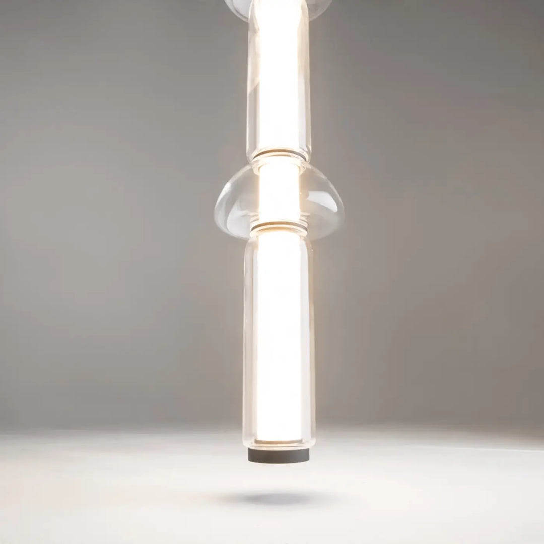 Suspension luminaire cosmo led linéaire avec verre transparent clair et design moderne à deux sections cylindriques verticales