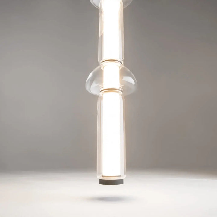 Suspension luminaire cosmo led linéaire avec verre transparent clair et design moderne à deux sections cylindriques verticales