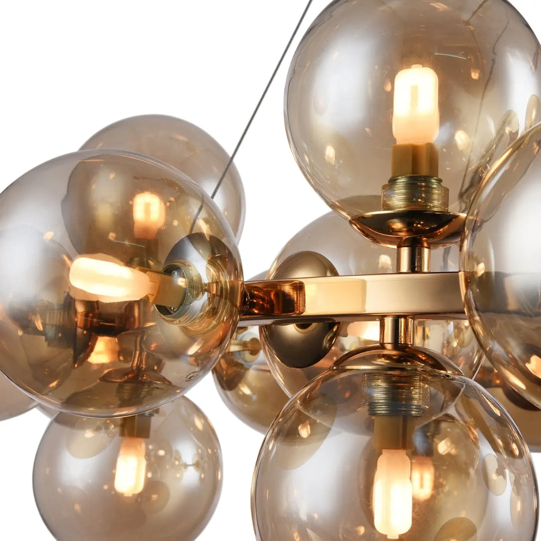Suspension luminaire dallas circulaire en laiton avec vingt-cinq globes en verre ambré pour un éclairage moderne