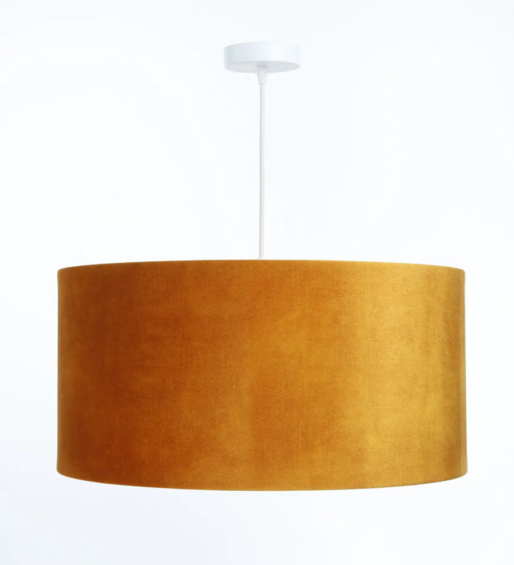 Suspension design dorée en velours jaune miel avec abat-jour textile et cordon blanc en matières naturelles
