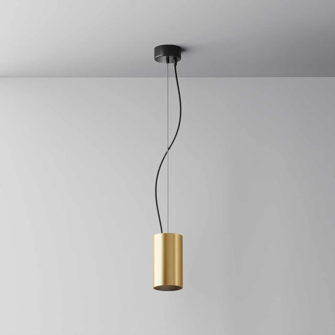 Suspension efir cylindre doré avec design minimaliste en métal suspendue par cordon noir au-dessus d’un îlot